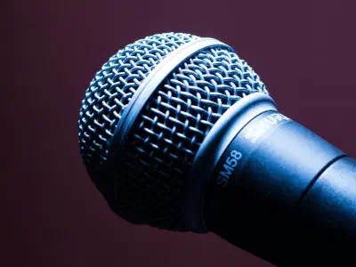 Microphone on a stand in front of an audience