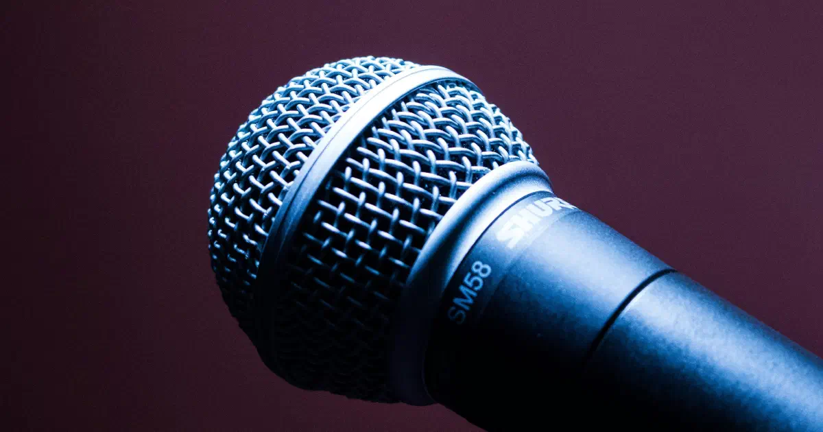 Microphone on a stand in front of an audience