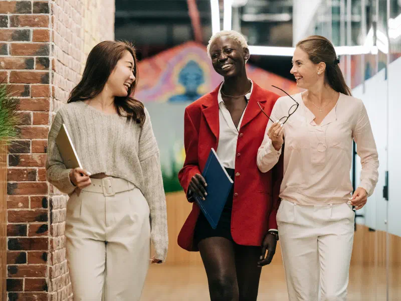 Two professional women walking and talking together