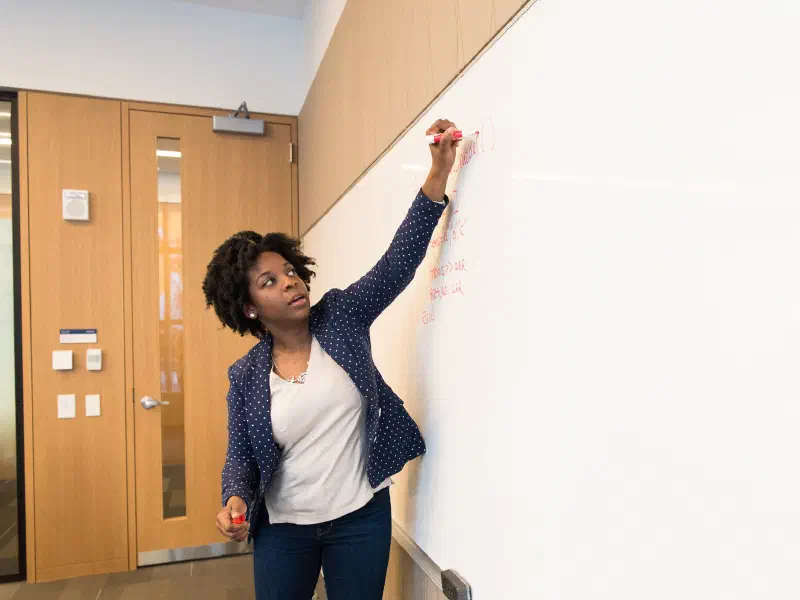 Woman of color working at a computer in a tech office
