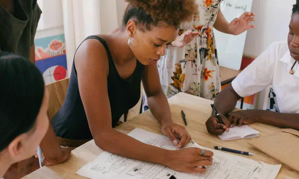 Group of women of color having a lively meeting around a table