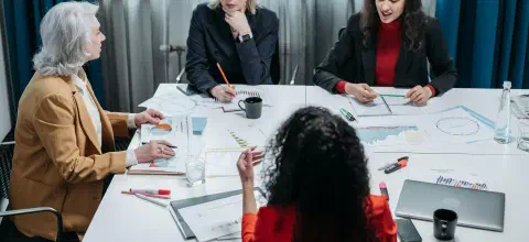 Women having an office meeting around a table